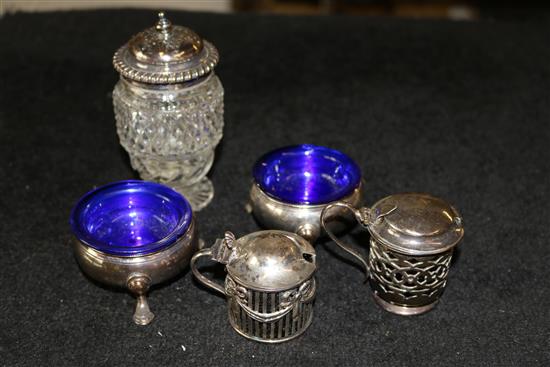 A pair of George III silver bun salts, two Edwardian silver mustards and a glass condiment pot